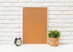 Workspace with corkboard, notebooks, and plants creating an organized study environment in a bright room photo