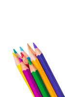 Vibrant colored pencils clustered together on a plain background ready for creative drawing and art projects photo