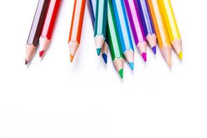 Colorful assortment of sharpened pencils arranged on a white background for artistic projects or creative activities photo