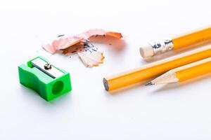 Tools for creativity and learning with yellow pencils and a sharpener on a clean surface photo