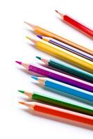 Colorful assortment of sharpened pencils arranged in a line creating a vibrant display on a white background photo
