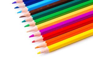 Colorful collection of sharpened pencils arranged in vibrant order on a white background photo