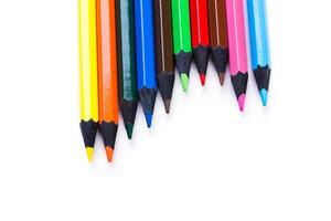 Vibrant colored pencils arranged in a line ready for creative projects on a clean white surface photo