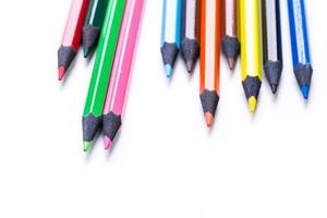 Collection of colorful pencils arranged neatly on a white background for art projects and creative activities photo
