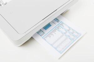 Printer working on a document with financial data in a home office on a bright afternoon photo