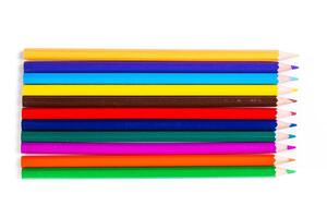 Colorful assortment of art pencils arranged in a row on a clean white background providing inspiration for creative projects photo