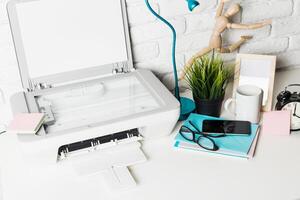 Modern workspace with printer, stationery, and plants in a bright, organized setting photo