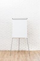 Blank flip chart in a bright meeting room ready for brainstorming and collaboration session in a modern office environment photo