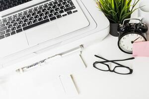 Workspace with laptop and printer displaying organized office essentials in a bright and tidy environment photo