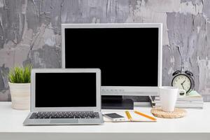 Modern workspace setup featuring technology and personal items for productivity in a contemporary environment photo