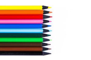 Collection of colored pencils arranged in a neat row on a white background for art and creativity photo