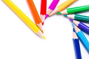 Colorful assortment of colored pencils arranged in a circular pattern on a white surface for creative art projects photo