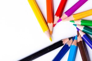 Vibrant colored pencils arranged in a circular pattern on a white surface during a creative art session photo