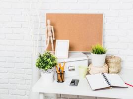 Workspace arrangement with decorative elements and organizational tools on a bright desk photo