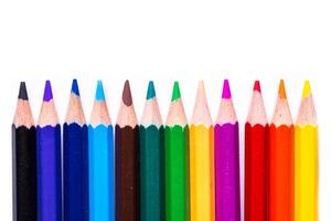 Colorful set of pencils arranged in a row showcasing a vibrant spectrum against a white background photo