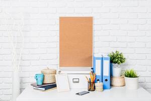 Minimalist workspace setup with organizational tools and decorative plants in a bright environment photo
