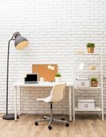 Modern home office setup with desk, computer, and decorative plants in bright environment photo