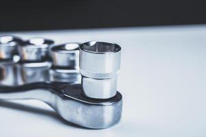 High-quality socket wrench set displayed on a workbench with focus on a socket attachment photo