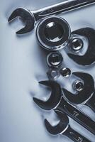 Metal tools arranged neatly on a light surface highlight craftsmanship and precision in mechanical work photo