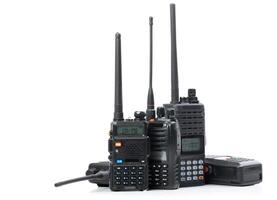 Variety of handheld radio communication devices arranged on a white background showcasing different models and sizes photo