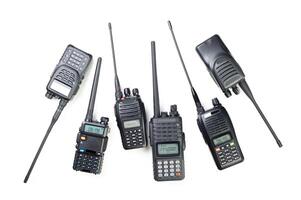 Multiple handheld radios arranged on a white background showcasing various designs and features for communication purposes photo