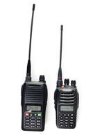 Two black handheld radios for communication with antennas displayed on a white background photo