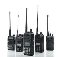Various models of handheld radios on display with different antenna lengths and features photo