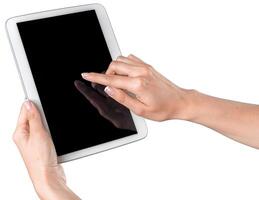 Person interacts with a tablet screen using their fingertip in a bright setting photo