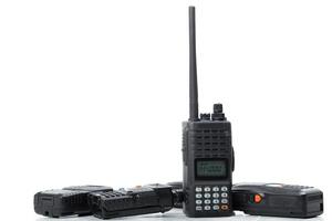 Collection of handheld radios displayed on a white background for communication purposes and emergency use in various situations photo