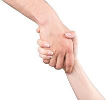 Two hands engaged in a firm handshake, symbolizing trust and collaboration in a professional setting photo