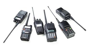 Various handheld radios displayed on a white background for communication and signaling purposes photo