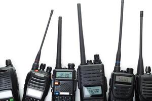 Various handheld radios displayed on white background for communication technology enthusiasts photo