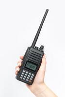 Handheld communication device held by a person with long nails in a bright environment photo