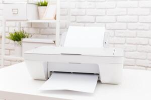 Modern printer in a bright workspace printing document on a clean desk with white brick wall background photo