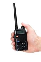 Handheld two-way radio being held for communication in a clear setting photo