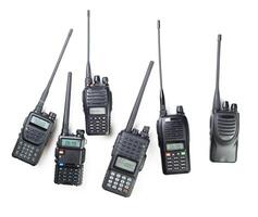 Collection of various walkie-talkies arranged on a white background showcasing communication devices in detail photo