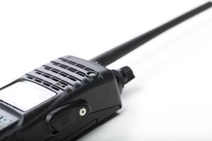 Communication device is placed on a white surface with a long antenna during a quiet moment photo