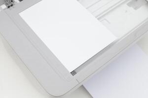 Scanner showing blank paper ready for scanning documents in a well-lit home office environment photo
