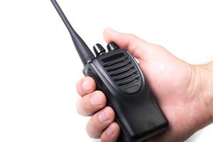 Handheld radio in use during communication at an outdoor event in bright daylight photo