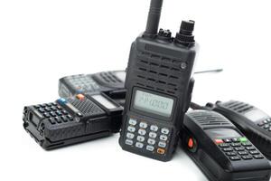 Multiple handheld radios arranged on a table showcasing communication equipment commonly used in various industries photo