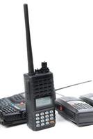 Two walkie talkies and a radio with antenna in a close-up display on a white background showcasing communication tools photo