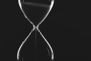 Sand flows steadily in an hourglass creating a captivating visual of time's passage photo