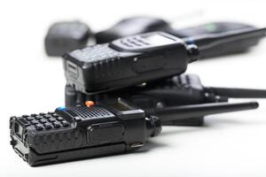 Collection of handheld communication devices primarily used for outdoor activities and emergency situations in a neutral setting photo