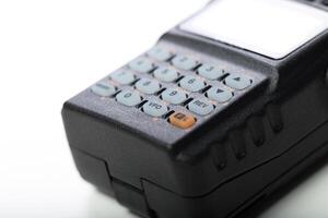 Vintage handheld communication device with keypad displayed on a neutral surface photo