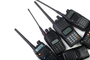 Collection of handheld walkie-talkies arranged on a white background showcasing various models and features photo