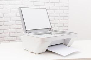 Printer sits on a table with a blank page loaded, ready for documents in a bright, minimalistic office space photo