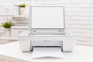 Printer situated on a desk printing a blank document in a bright and minimalist workspace photo