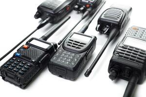 Different models of two-way radios arranged on a flat surface for communication and operational purposes photo