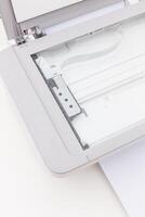 Modern scanner showing internal mechanism and paper path on a clean white surface photo