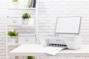 Printing documents in a modern workspace with a sleek printer on a white table against a brick wall photo